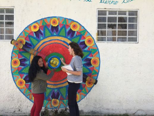 A resident explaining a Street Art installation produced during the last community art biennale to Paola