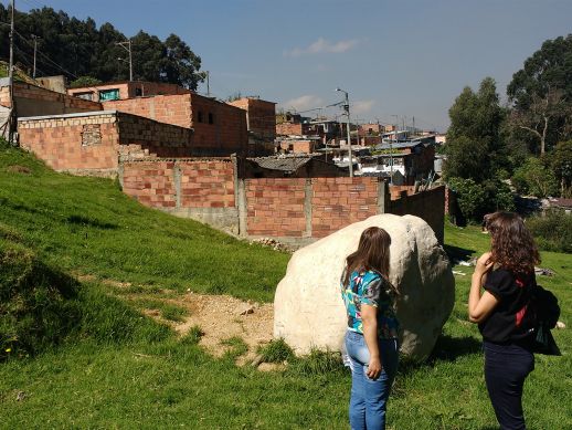 Claudina telling Paola about the history of the neighborhood